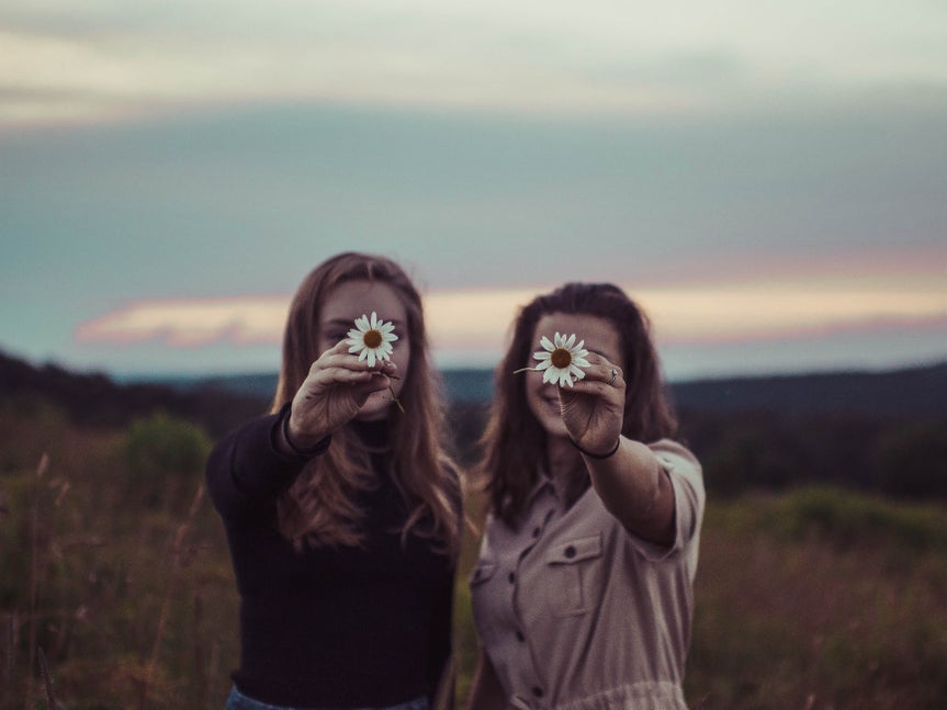 Two women holding flowers