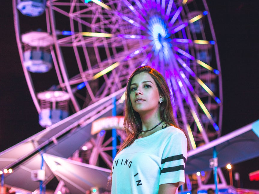 woman in front of ferris wheel