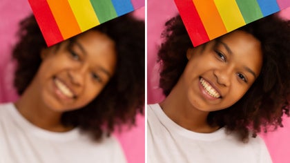 woman with a rainbow flag touching her face