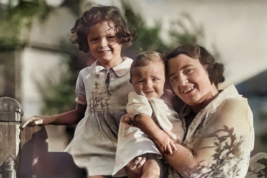 vintage black and white family photo of a mother and two children after the old photo restorer is applied