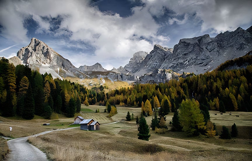 mountains with a forest and cabin the foreground