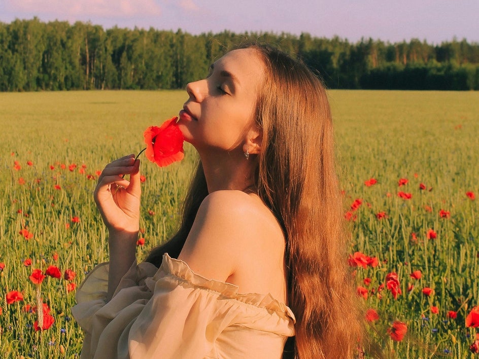 female model in field of poppies